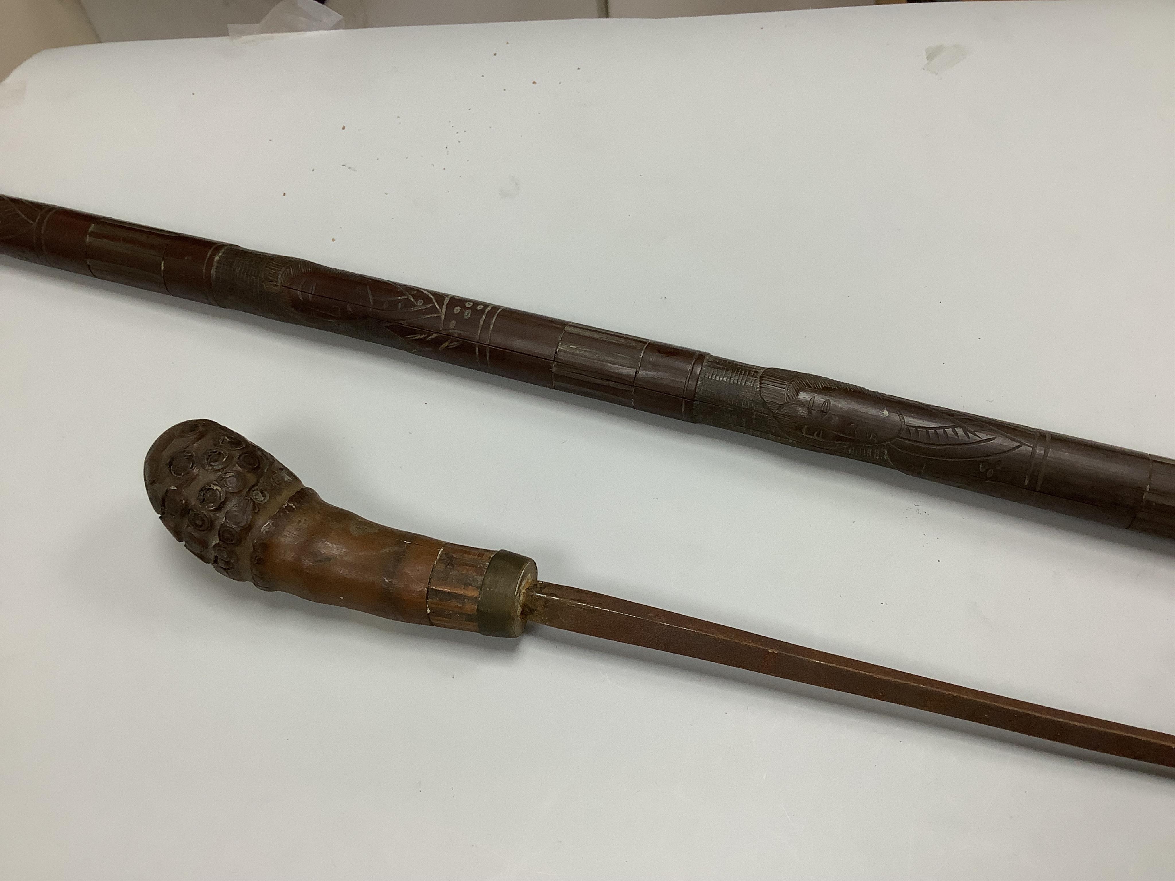 An officer’s sword, three walking sticks and an antique sword stick, longest walking stick 92cm long